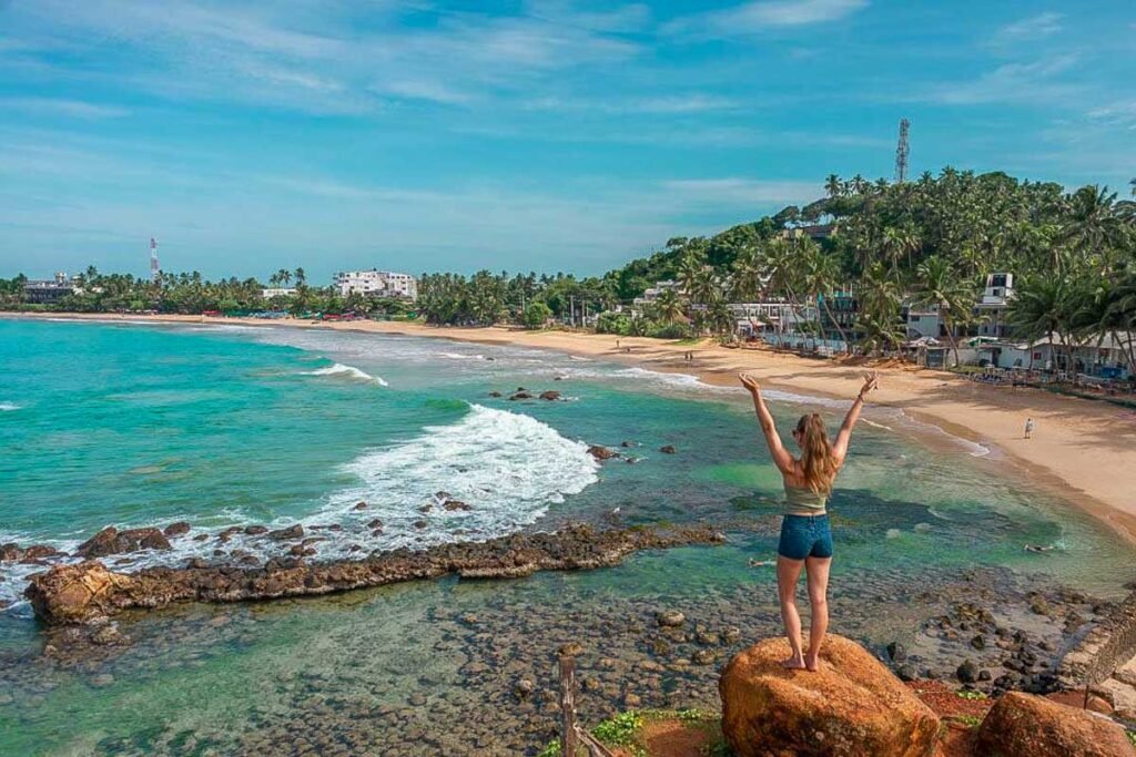 Traveller on the rocks at Mirissa beach