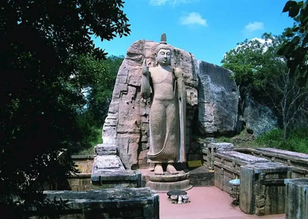 Ancient standing Buddha statue carved in stone